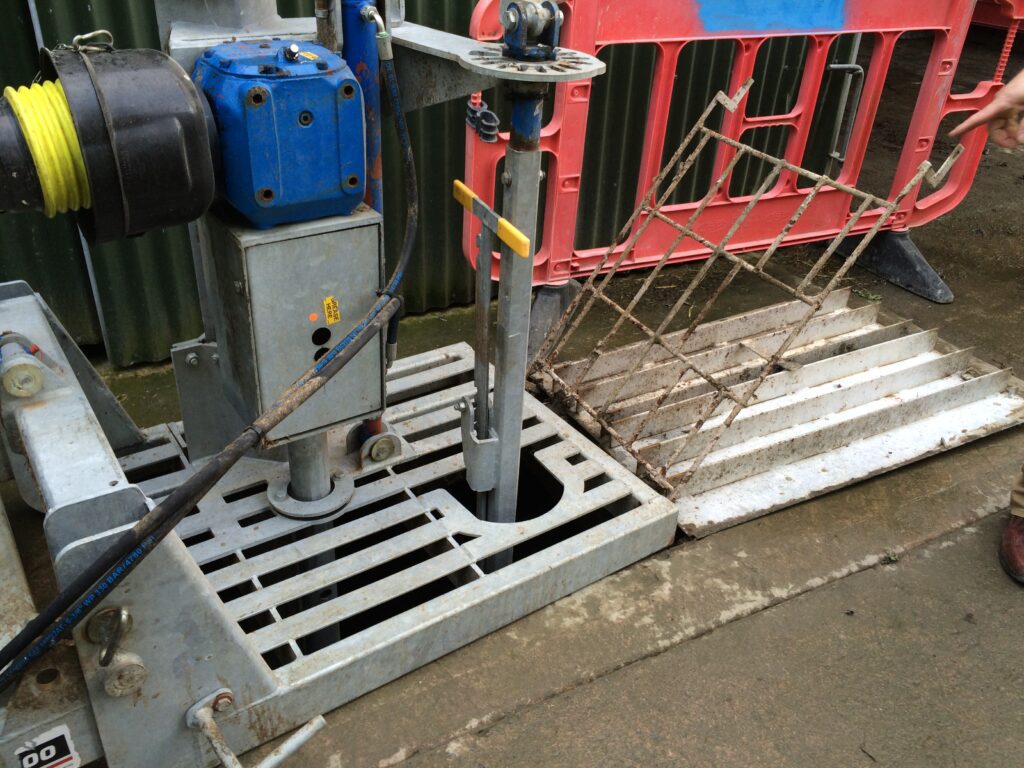 Agitating a slurry tank at an access point located outside the shed.