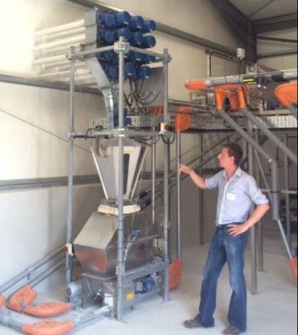 Tomas Ryan shows the workings of the Big Dutch Man feeder. Source: Shane McAuliffe