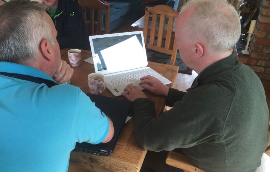 Barry Lynch (left) shows Michael Harlin (right) how to use the Agrinet system