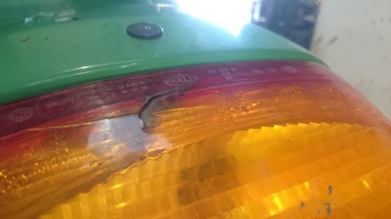 A cracked tail light on a tractor