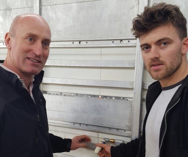 Angus Woods and James Scallan examining a modified teat drinker, which is necessary on trucks transporting calves to the Netherlands