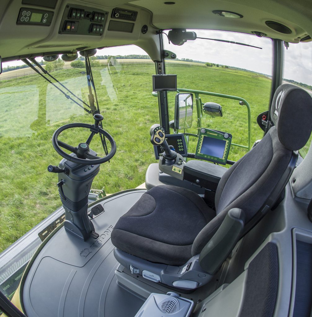 A view from inside the cab of a modern Krone forager
