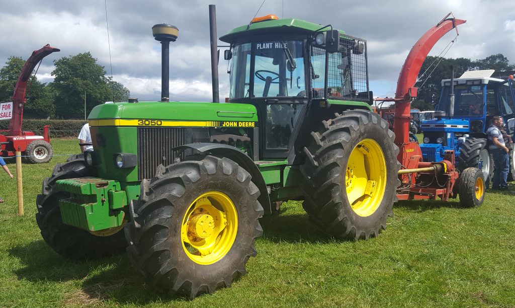 What event of this kind would be complete without a 6-cylinder 50 Series John Deere. This 4WD 92hp 3050, clearly a hedge-cutting tractor judging by the mesh guard on the nearside window, was teamed up with a Taarup harvester. This tractor is owned by Jim Hennessy Plant Hire