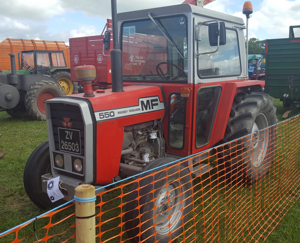 If she’s not red, leave her in the shed: This little, Perkins-powered (3-cylinder) MF 550 (47hp) was teamed up with a side-mounted harvester for the big task that lay ahead. It appeared to be the only 500 Series tractor at the event
