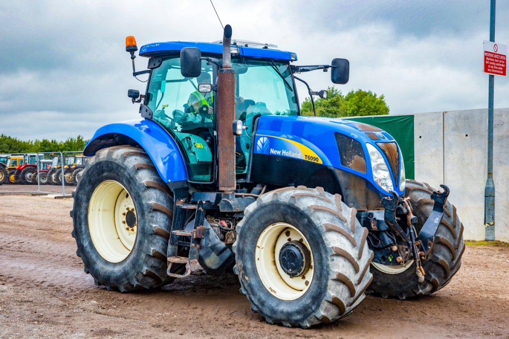 ‘If it’s not blue, it just won’t do’: This 2010 New Holland T6090, equipped with front linkage and air brakes, made £22,000. It had 7,927 hours on its odometer