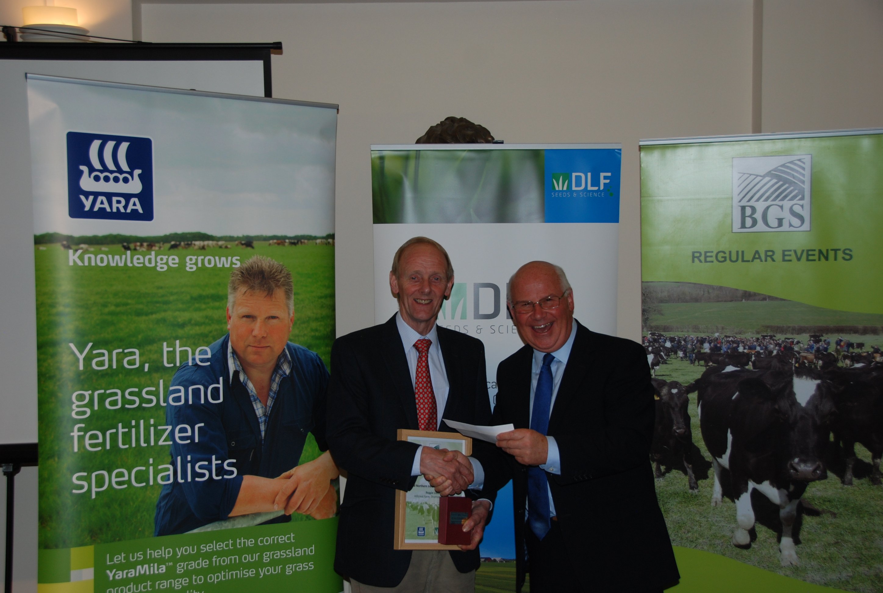 Beattie Lilburn receives a voucher for £250 (€282) worth of DLF seed from Paddy Jack, DLF Business Manager Scotland. DLF is a joint sponsor of the British Grassland Society Grassland Farmer of the Year Award