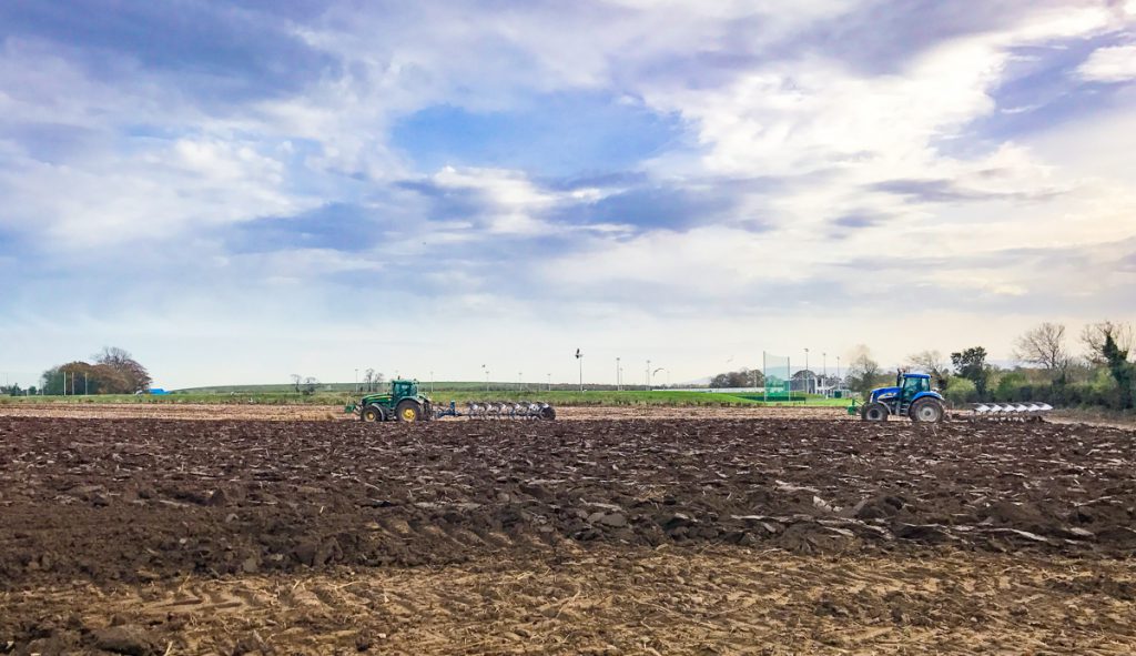 The Football Association of Ireland (FAI) training ground looms in the background, as two of Paud Flynn &amp; Sons’ ploughs work ahead of the drill