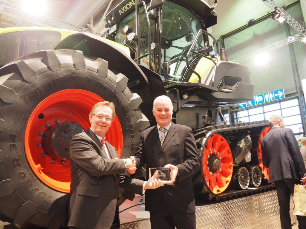 Alan Douglas (right) receiving a Claas dealer award