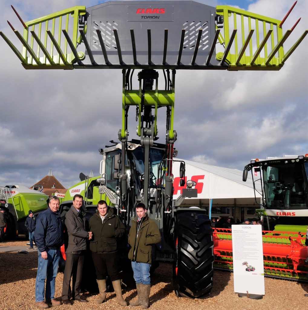 David, Richard and Tom Metcalfe of Metcalfe Farms (England) being presented with their new Torion 1914 by Trevor Tyrrell, CEO of Claas UK, at LAMMA 2018 last week
