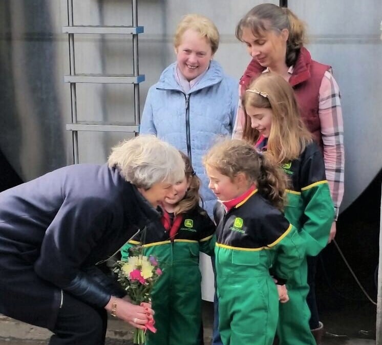 The girls pictured with Theresa May