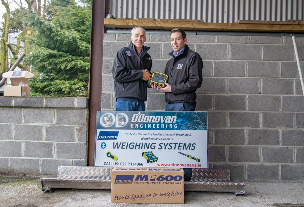 Philip Sweetnam, from O’Donovan Engineering, presenting Tommy with his new weighing scales