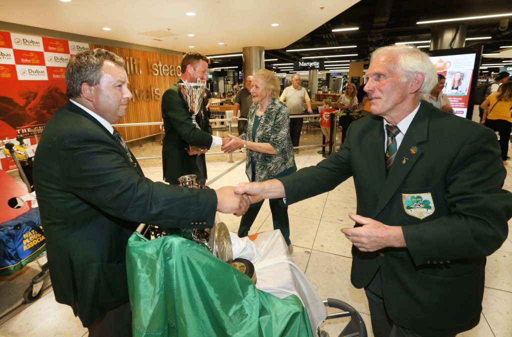 Liam O’Driscoll from Bandon, Co. Cork, is greeted by Anna May McHugh, NPA managing director, and Dan Donnelly from Blackwater, Co. Wexford. Image source: Finbarr O’Rourke