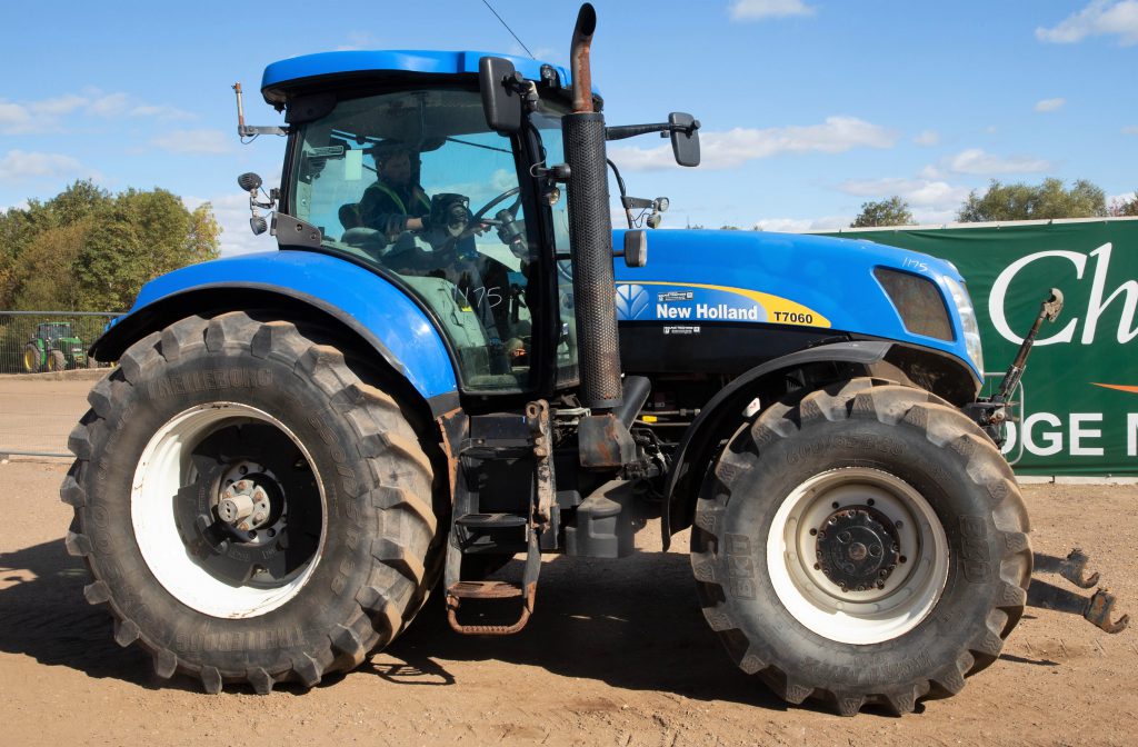This 2011 New Holland T7060 (Power Command; 50kph; air brakes; front axle and cab suspension; 5t front linkage; 'auto-steer' ready; 9,351 hours) sold for £21,500