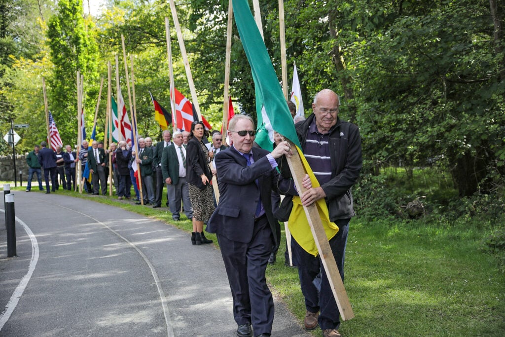 Seamus O’Donoghue and Danny O’Leary, who competed in the World Ploughing Championships of 1954, carrying the National Ploughing Association Flag. Image source: Valerie O’Sullivan