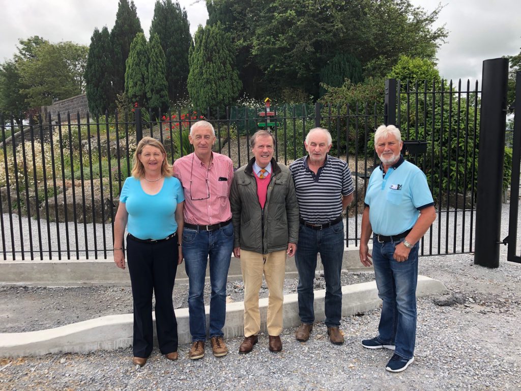 Residents in Bruree stand at the railings while the tidy towns rockeries and flowers remain steadfast on the inside