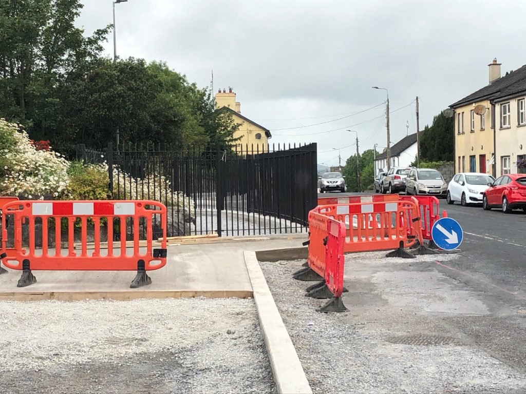 Railings have been installed and a new footpath in the heart of the village has taken half the road with it
