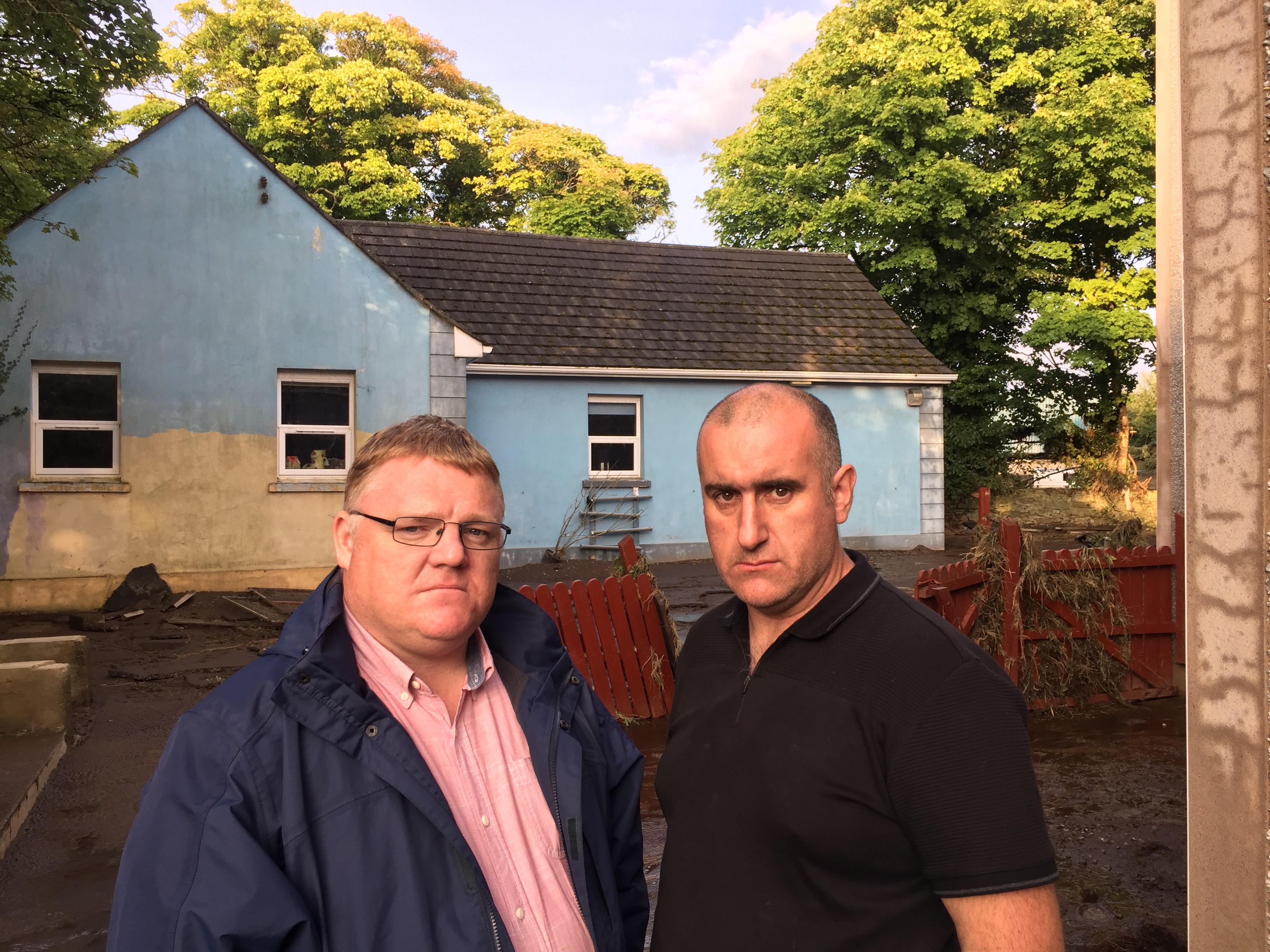 West Tyrone MLA Declan McAleer pictured with one of the farmers affected by floods in the north-west in 2017