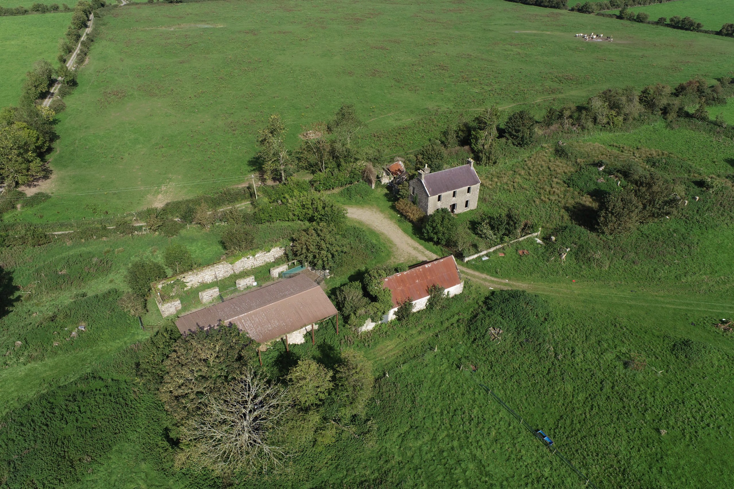The property includes outbuildings and a derelict house that is in need of repair