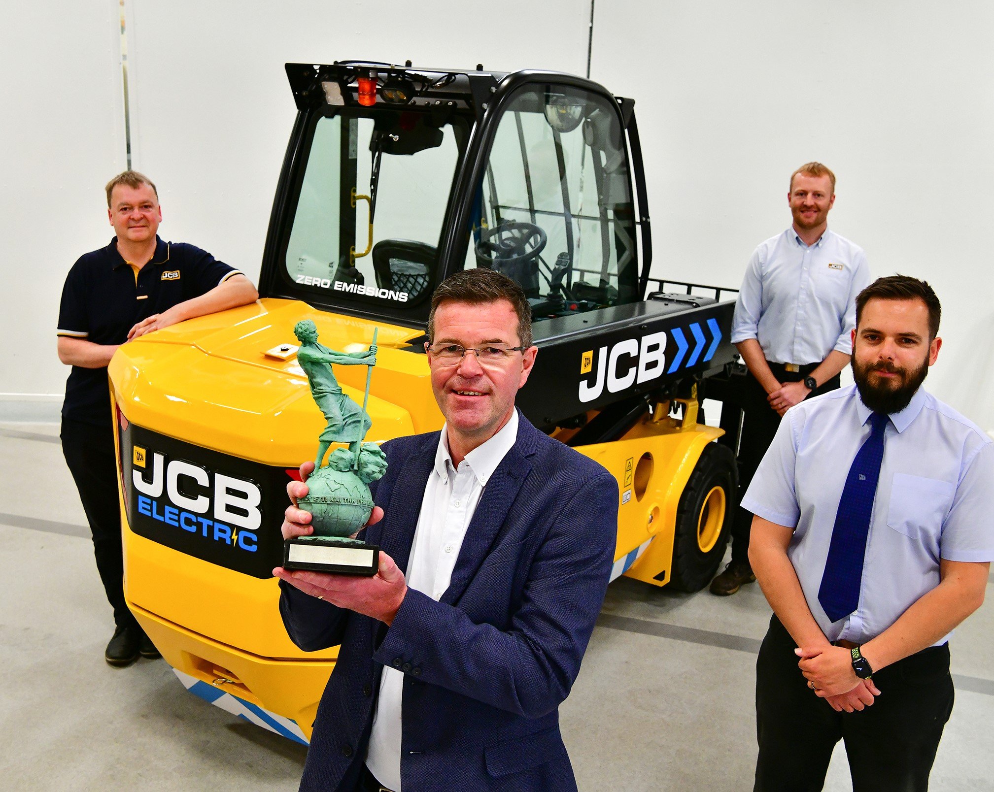 Paul Wild holding the Archie Award for the JCB TLTe. Also pictured from left: Rod Scott, Sam Wilkinson and Lee Harper