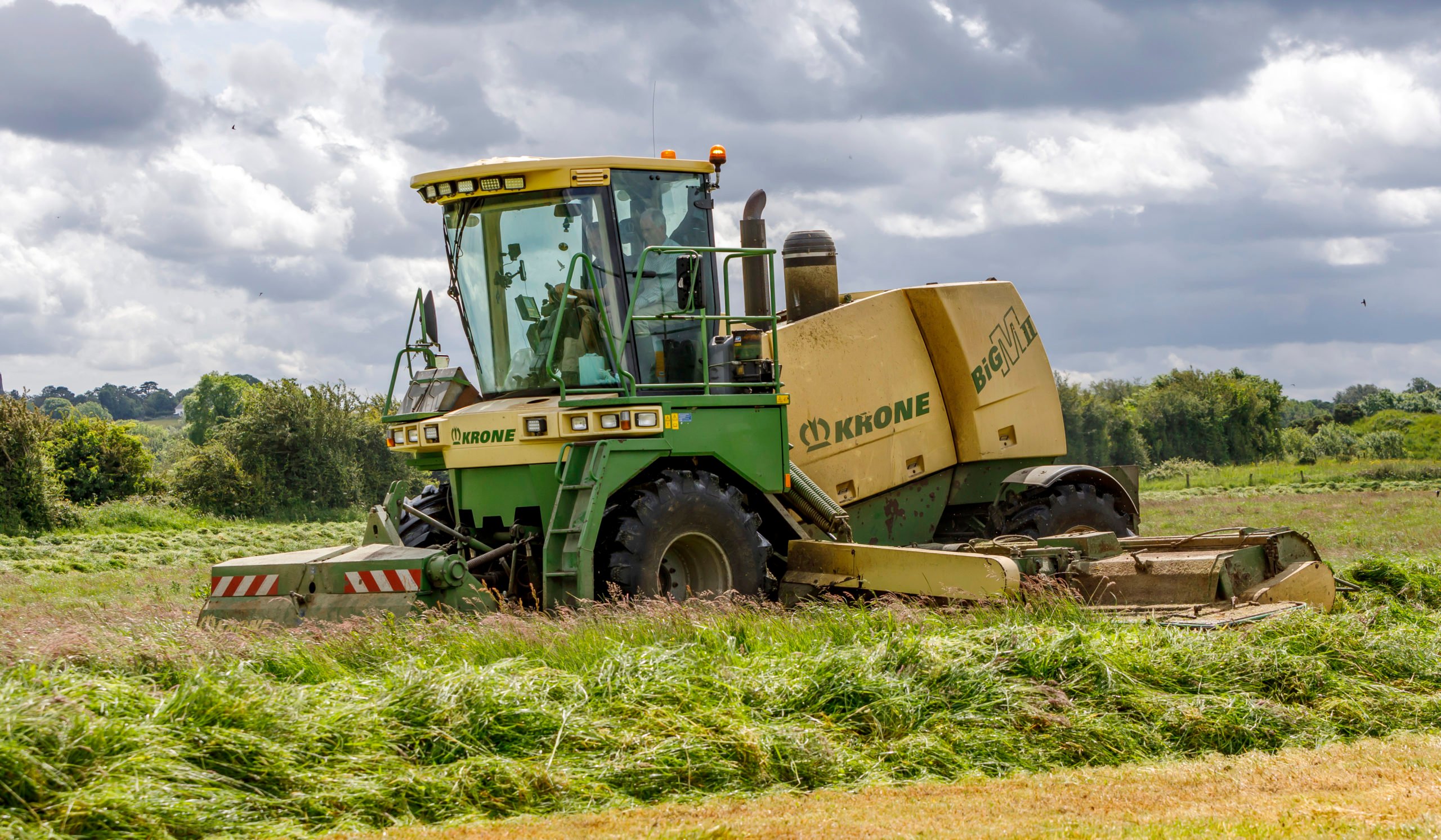 A BiG M in its element, working hard in a heavy crop