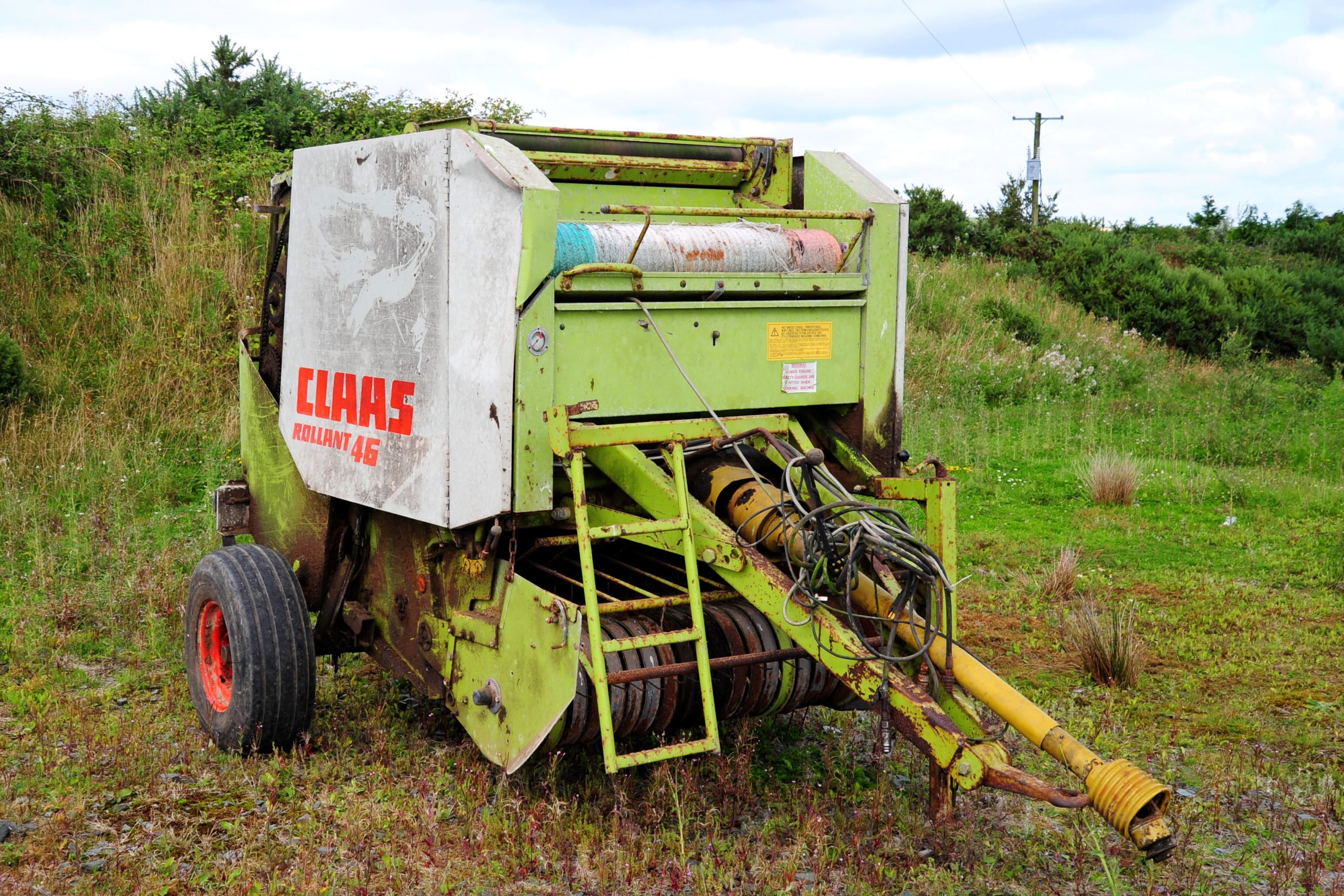 One of several round balers on offer, this neglected looking example still happily turns when powered up