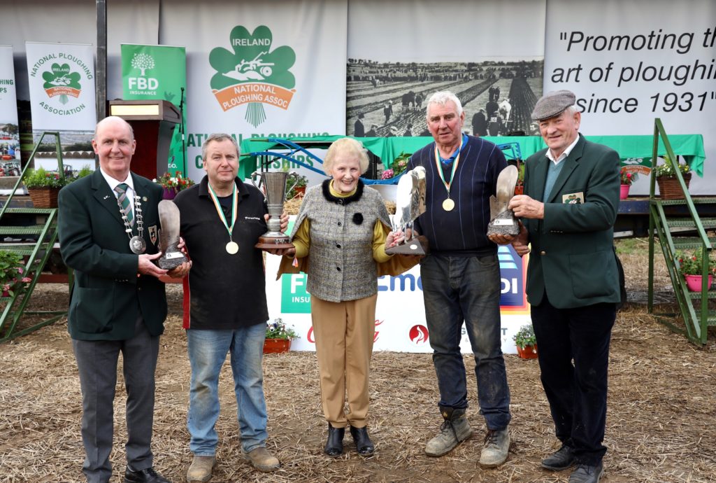 NPA managing director Anna May McHugh, president James Sutton and chairman Mick Mahon  congratulate the new National Conventional Ploughing champion Martin Kehoe and the new National Reversible Ploughing champion Dan Donnelly