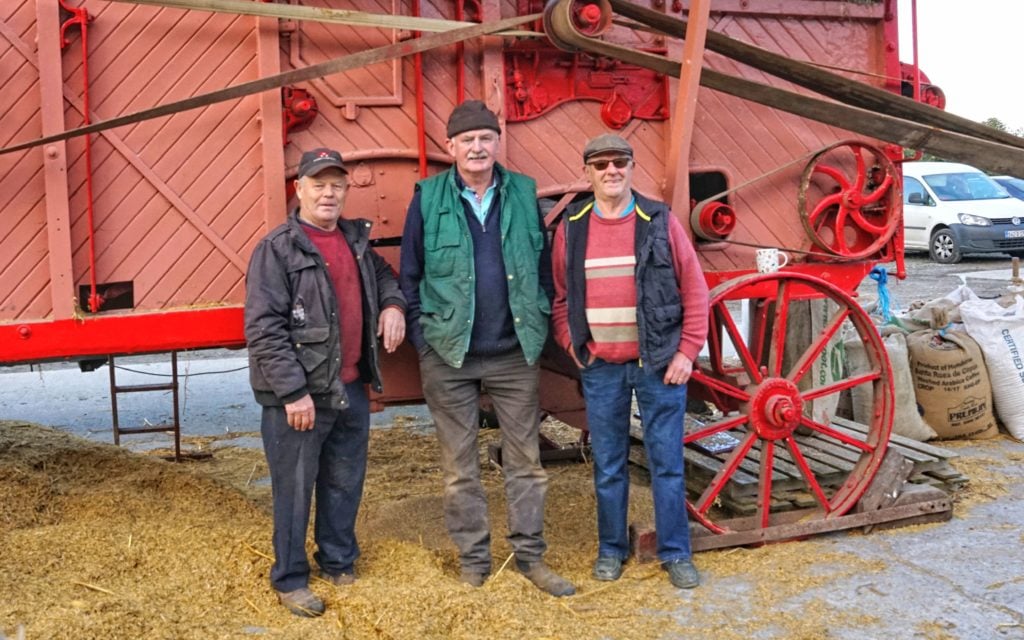 Patrick and Donal Kearney by the restored machine. Michael Fahy's (centre) father would help work the machine when it first arrived in Ireland