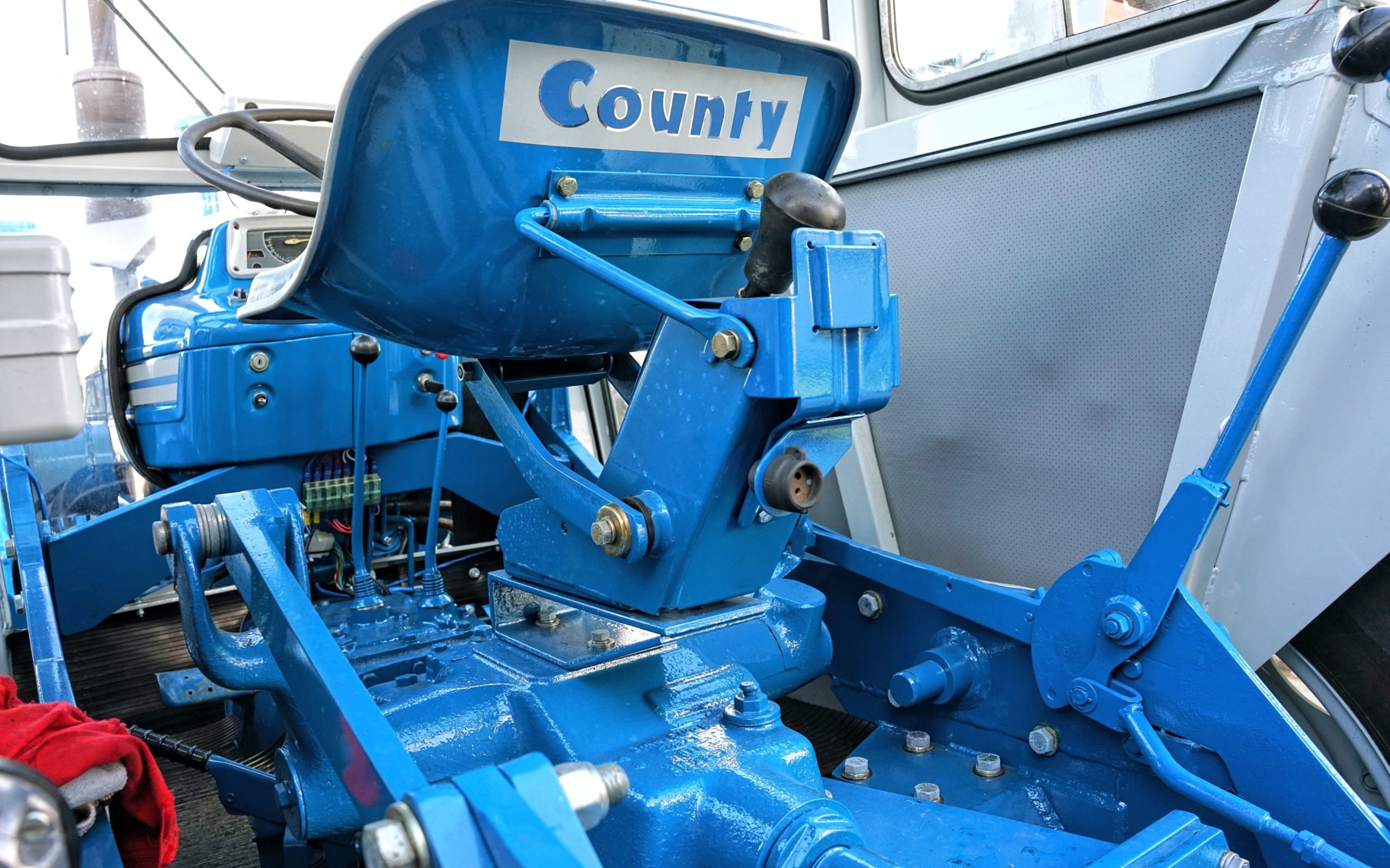 The loader frame runs through the cab and is attached to the rear housing