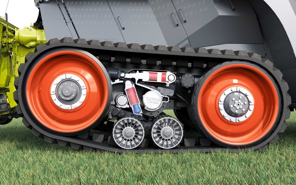 Hydraulic rams act to lift the ends of the track unit to reduce scuffing when turning on the headlands