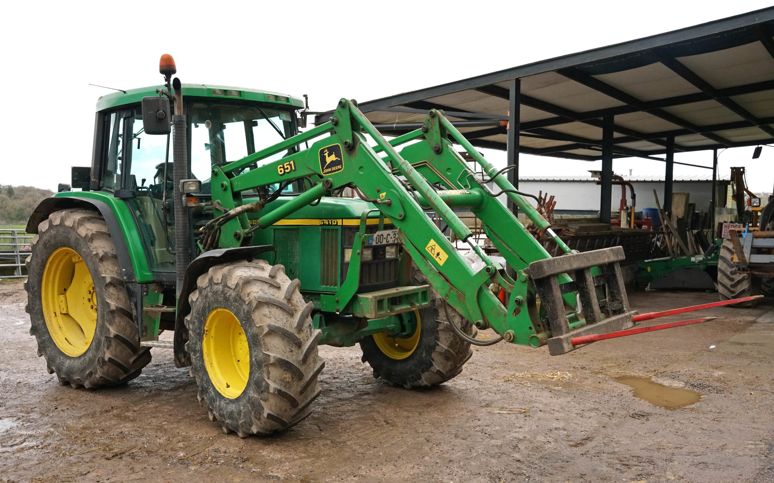 John Deere 6410 comes with a 651 loader which has a longer reach than the standard item