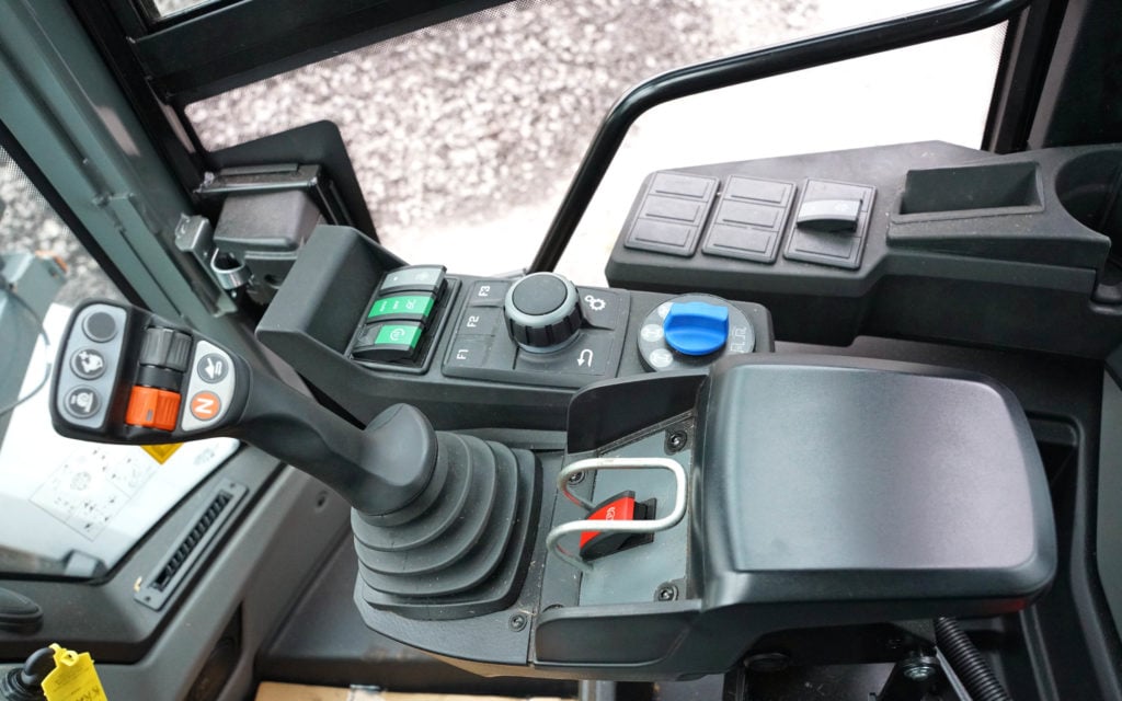 The control joystick is very much the same on each machine. The orange switch controls direction while the grey operates the boom