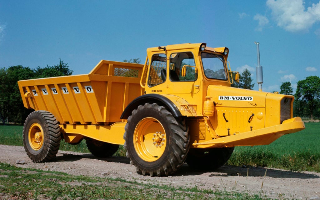 The company's first articulated dump truck, known as gravel Charlie, was introduced in 1966,. Note the 'trailer tyres' at the rear.