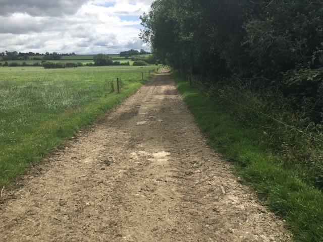 As seen above: Ensure roadway is sloped to field. Fenced should be placed between farm roadway and waterbody. For new farm roadways, fence should be placed 1.5 m from the top of the bank