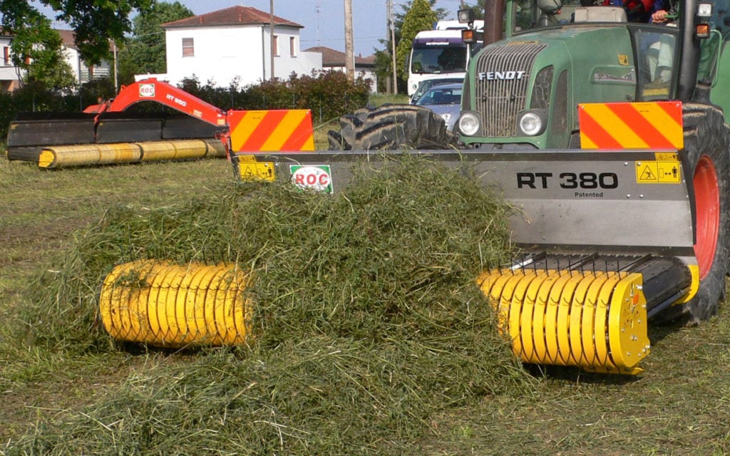 Belt rakes pick the crop up to transport it to its new position rather than throw it across