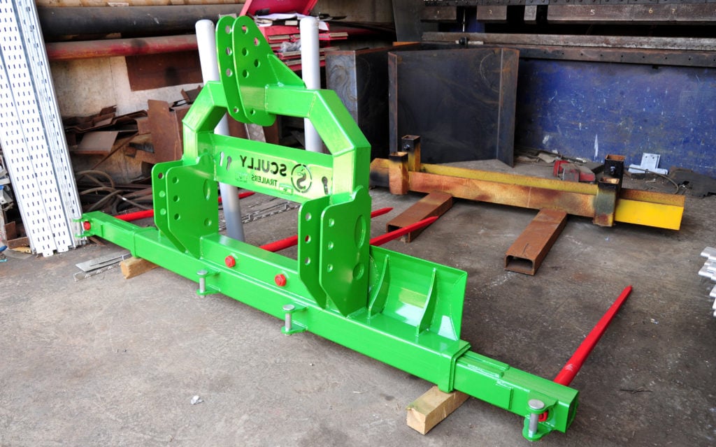 A twin bale handler with adjustable width awaits a delivery of hydraulic rams. Component supply is still an issue throughout the industry