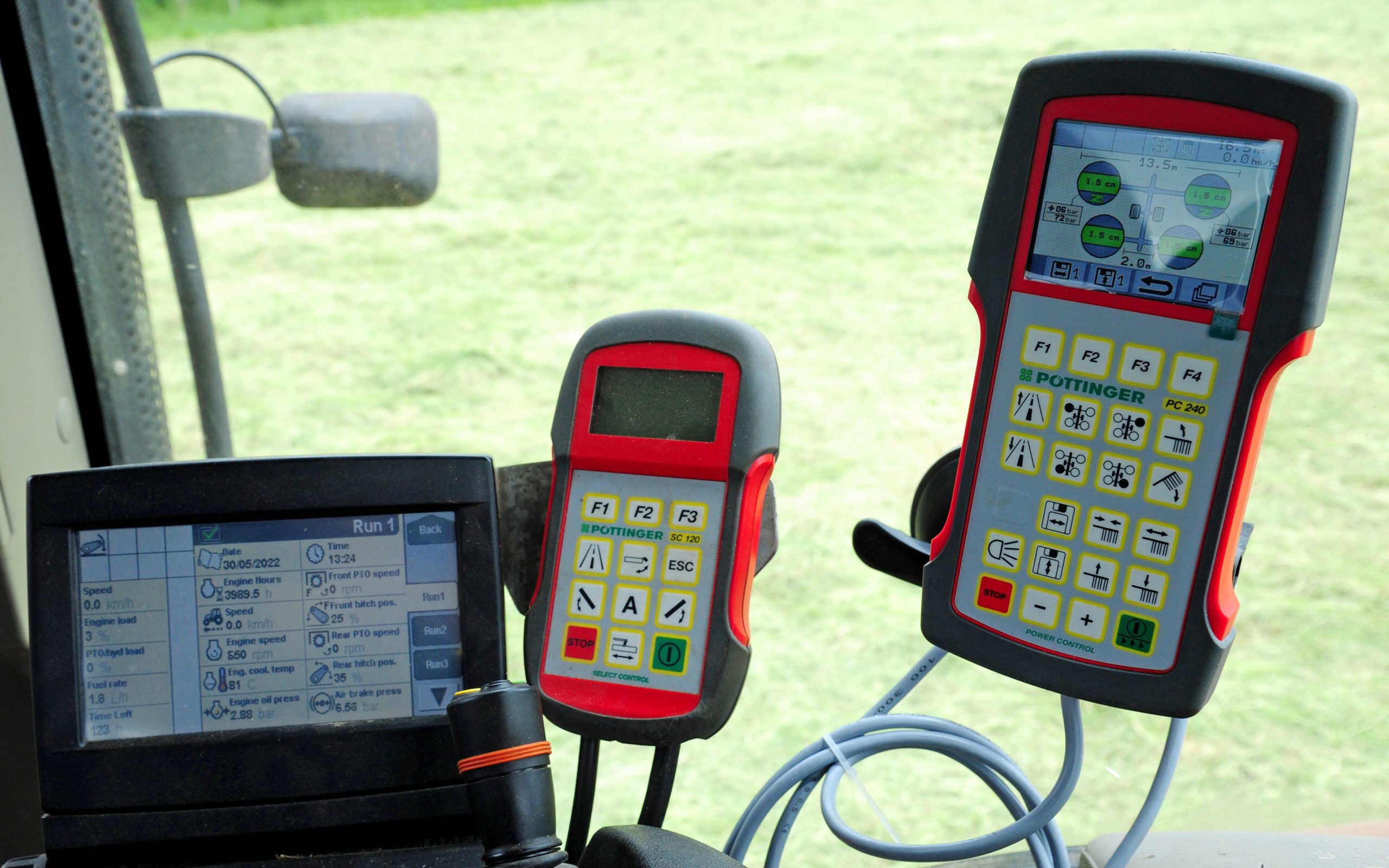 The rake control unit is on the right, the other two being that for a set of Pottinger mowers and the tractors own control screen