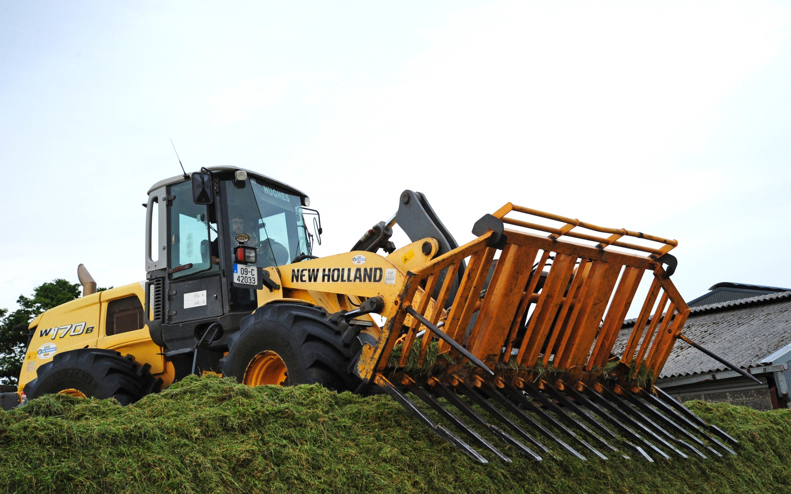 Back at the clamp a New Holland W170B takes care of the loader work