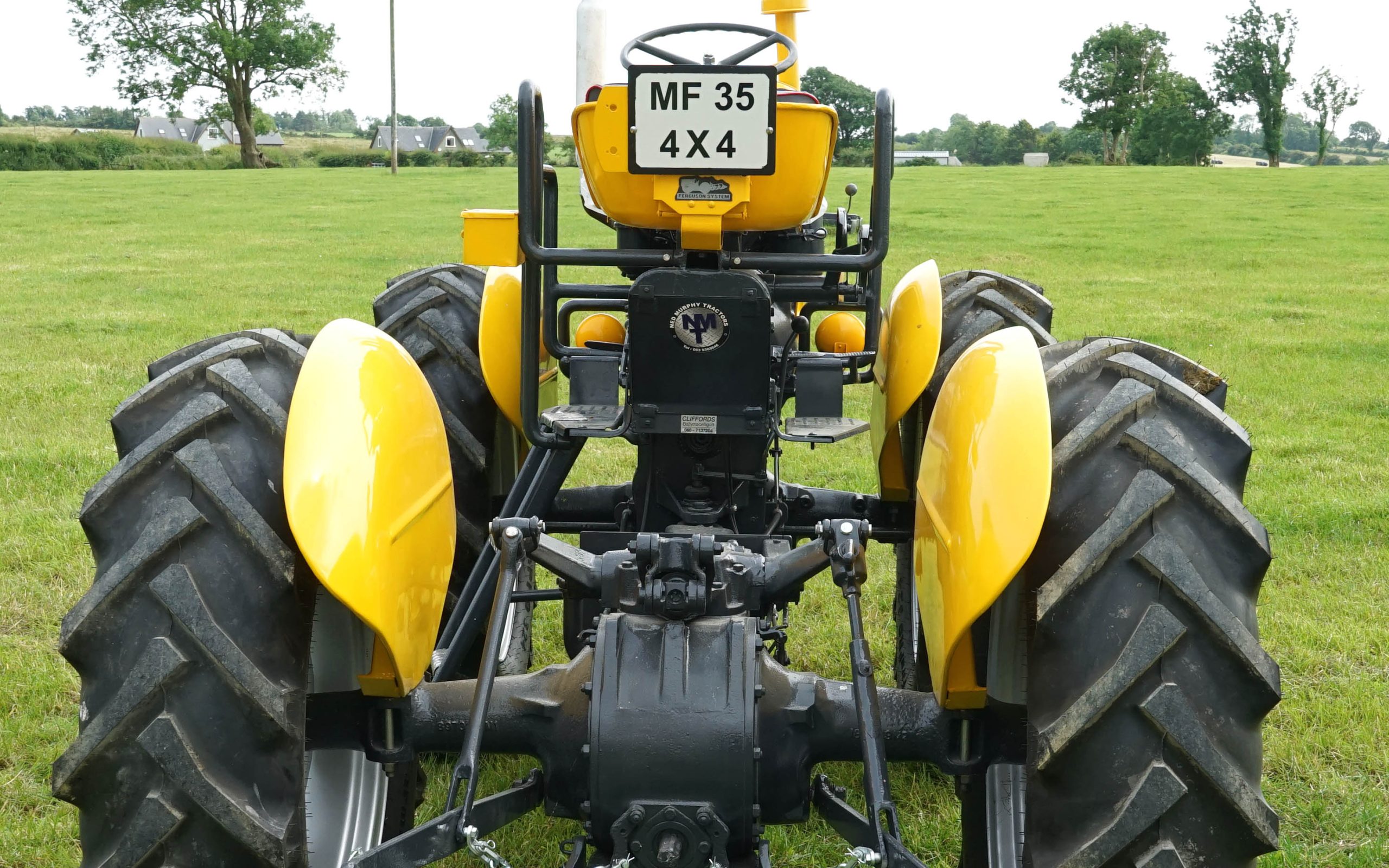 The rear axle of the tractor has been left as a standard MF 35 complete with working three-point linkage
