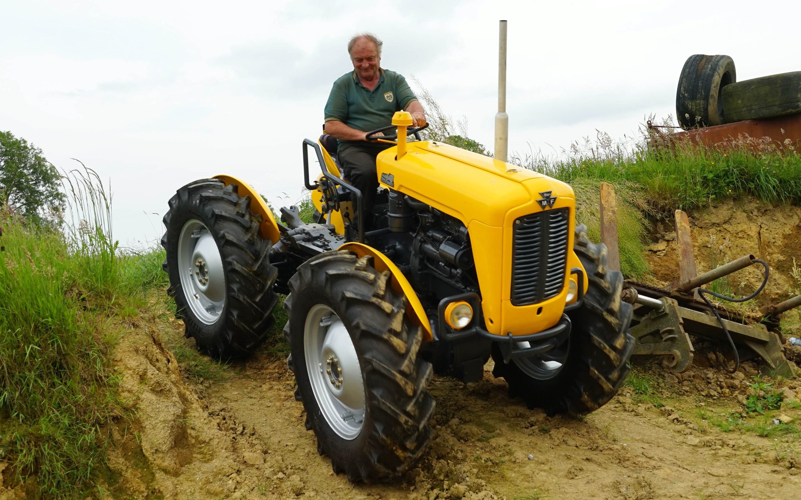 Norman at the wheel of his creation negotiating a steep slope