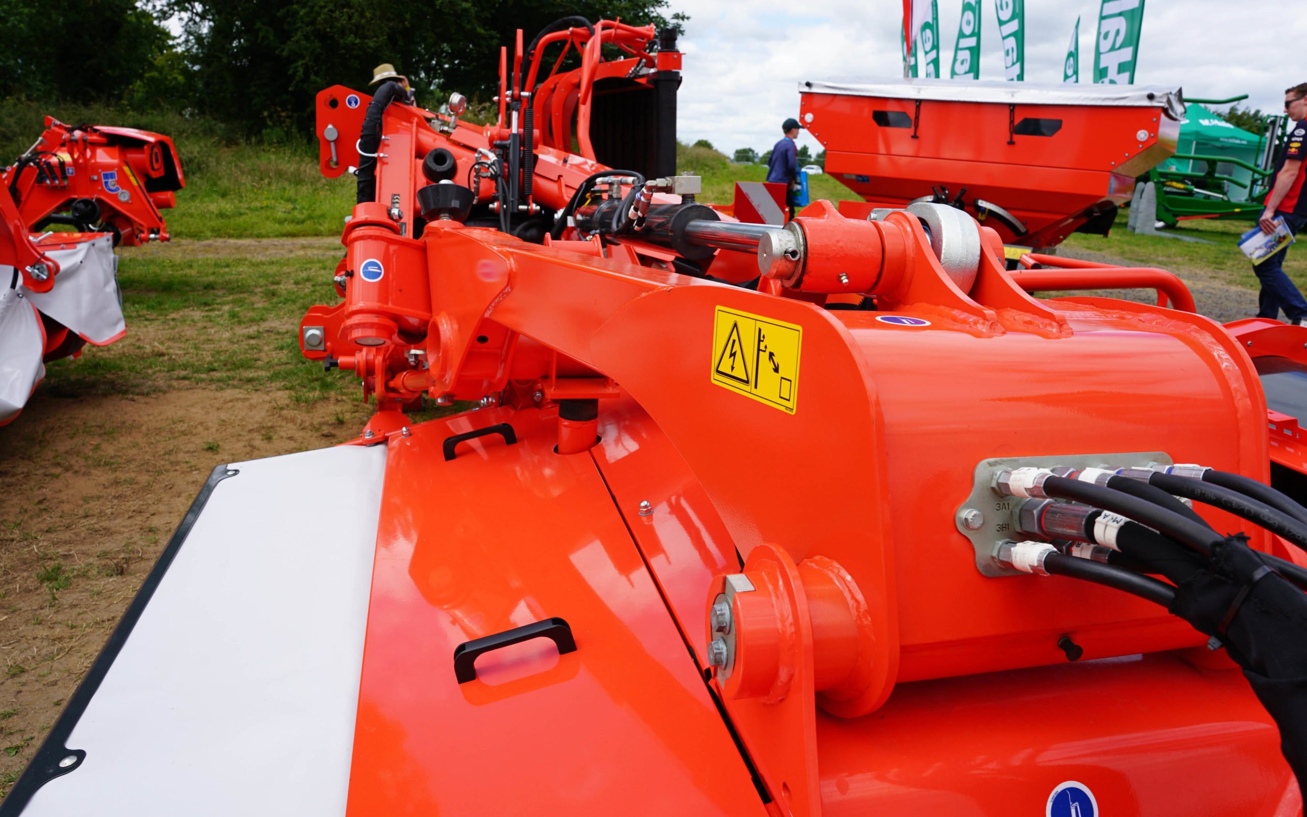 The hoods at the front of the mower retract when in transport mode