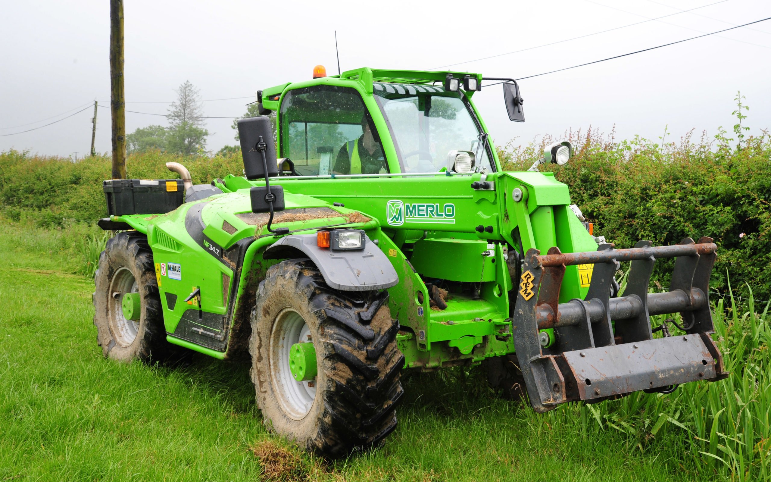 The boom is no more obtrusive than a front-end loader and stays attached to the machine