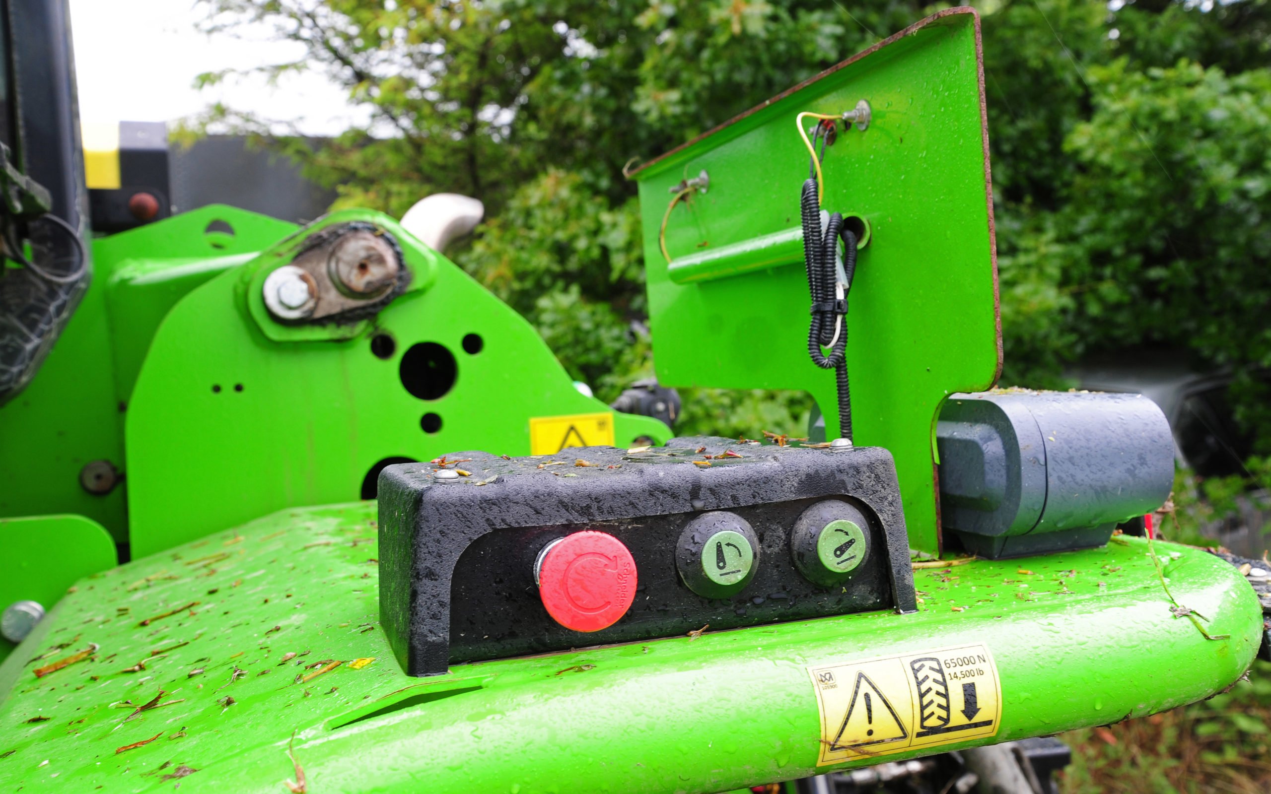 The lift arms can be operated from the mudguard while the red button stops everything, including the engine