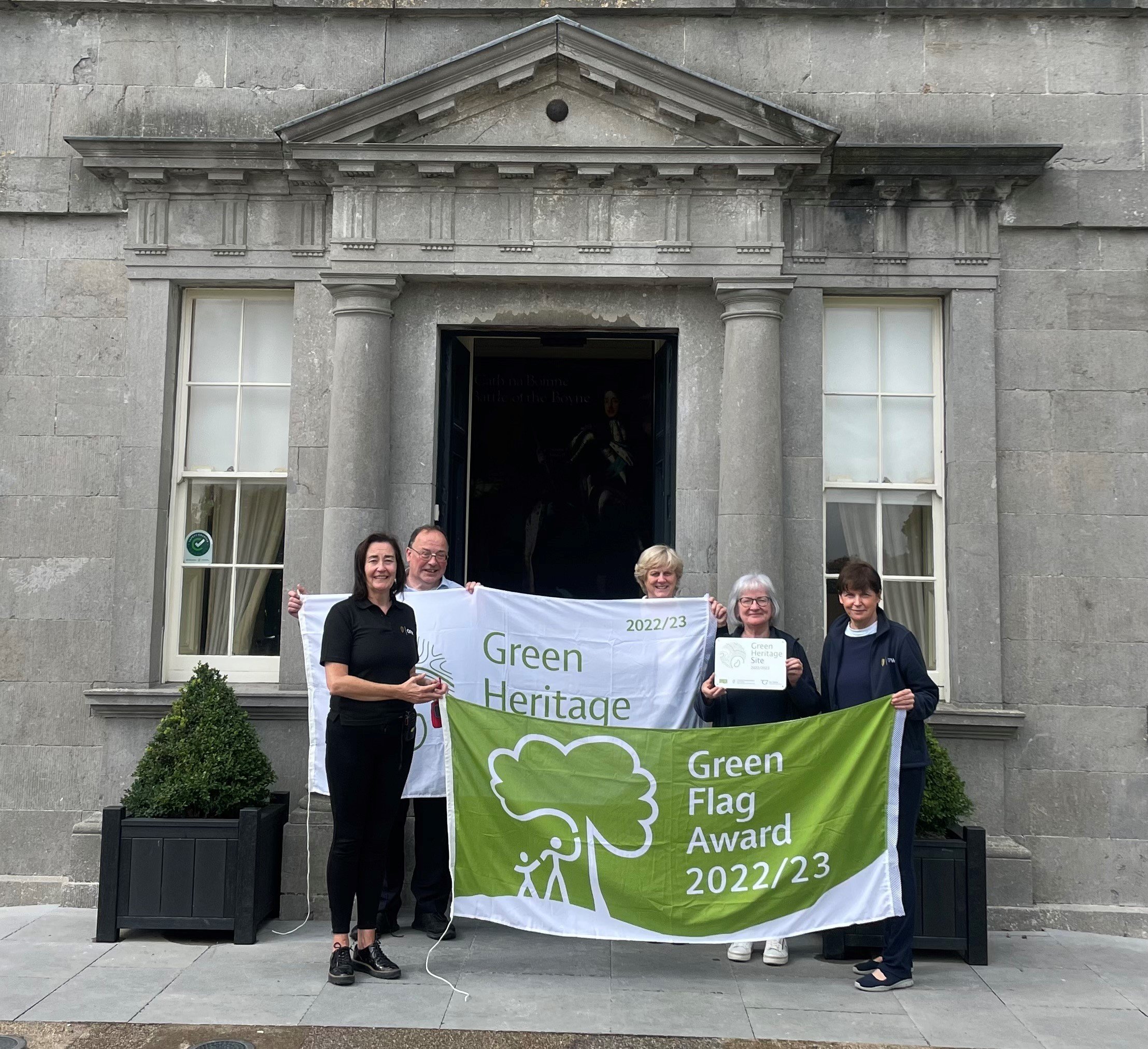 Staff at the Battle of the Boyne Visitor Centre proudly display their Green Flag for Parks and Green Flag Heritage flags