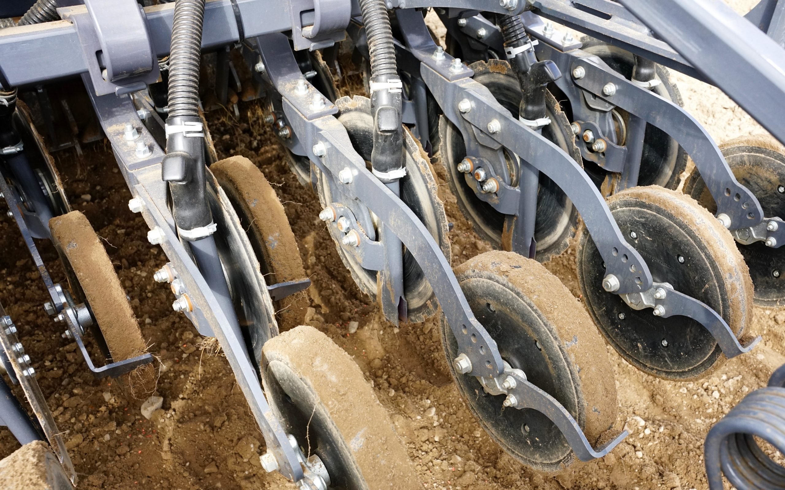 Out of work the chute can be clearly seen. It opens the slit cut by the disc, deposits the seed and clears the disc of soil