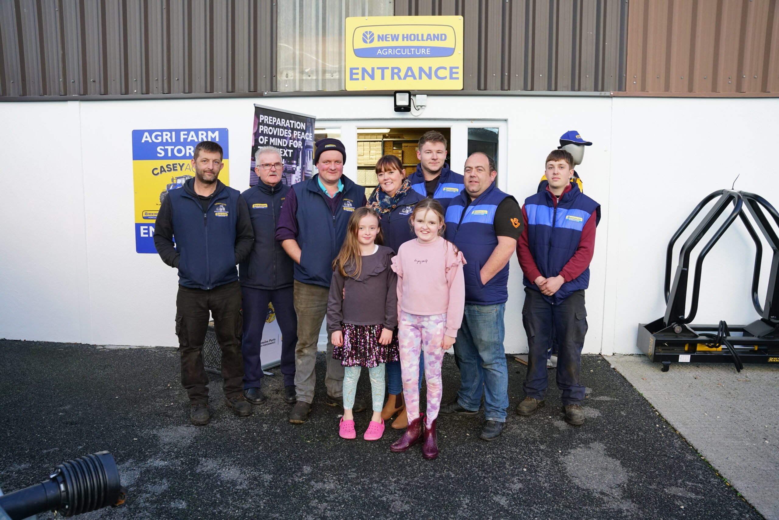 Bob and Denise Casey (centre) with staff and next generation of tractor enthusiasts