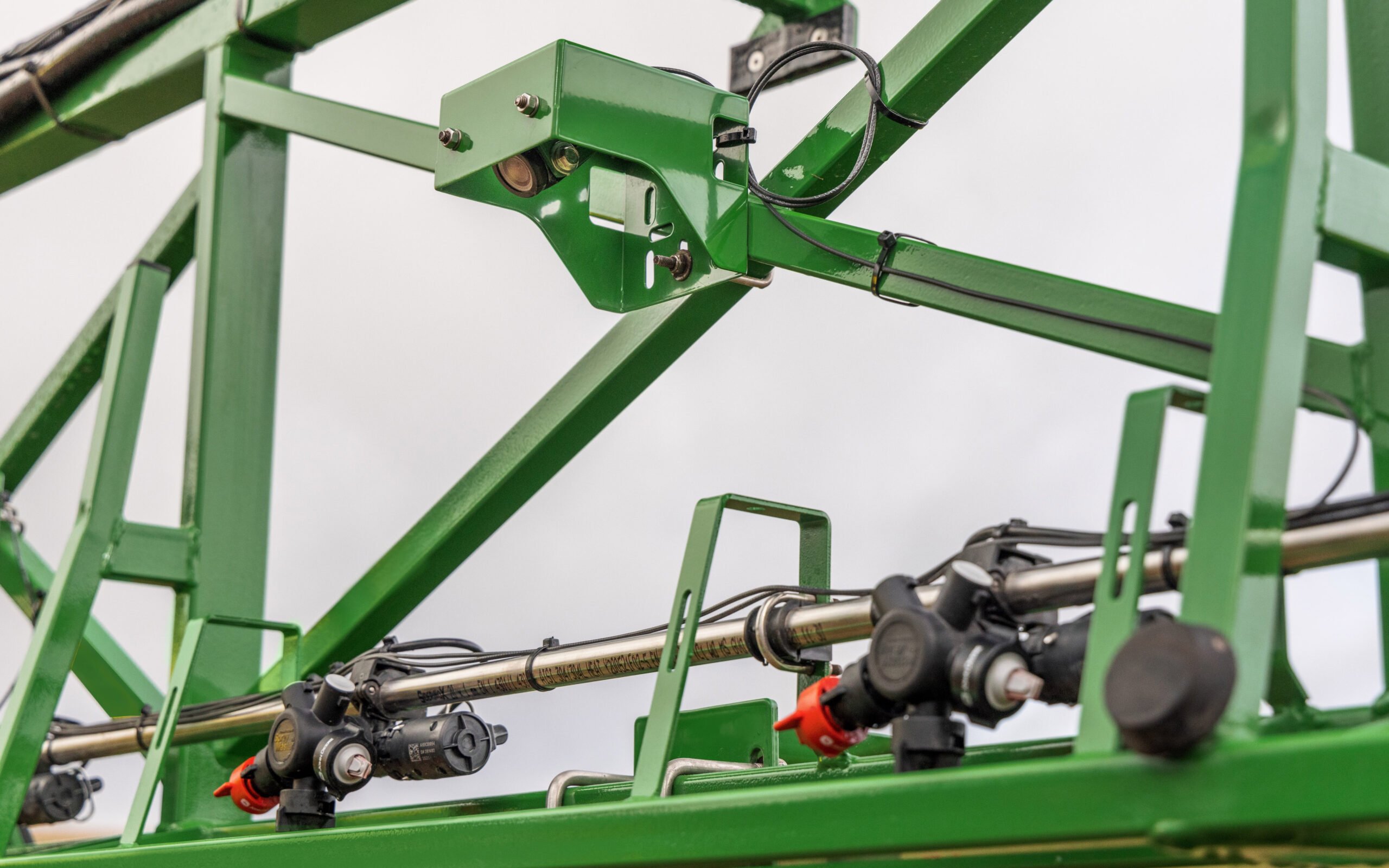 When green is detected where there should be none, the nozzles are triggered to spray the offending plant