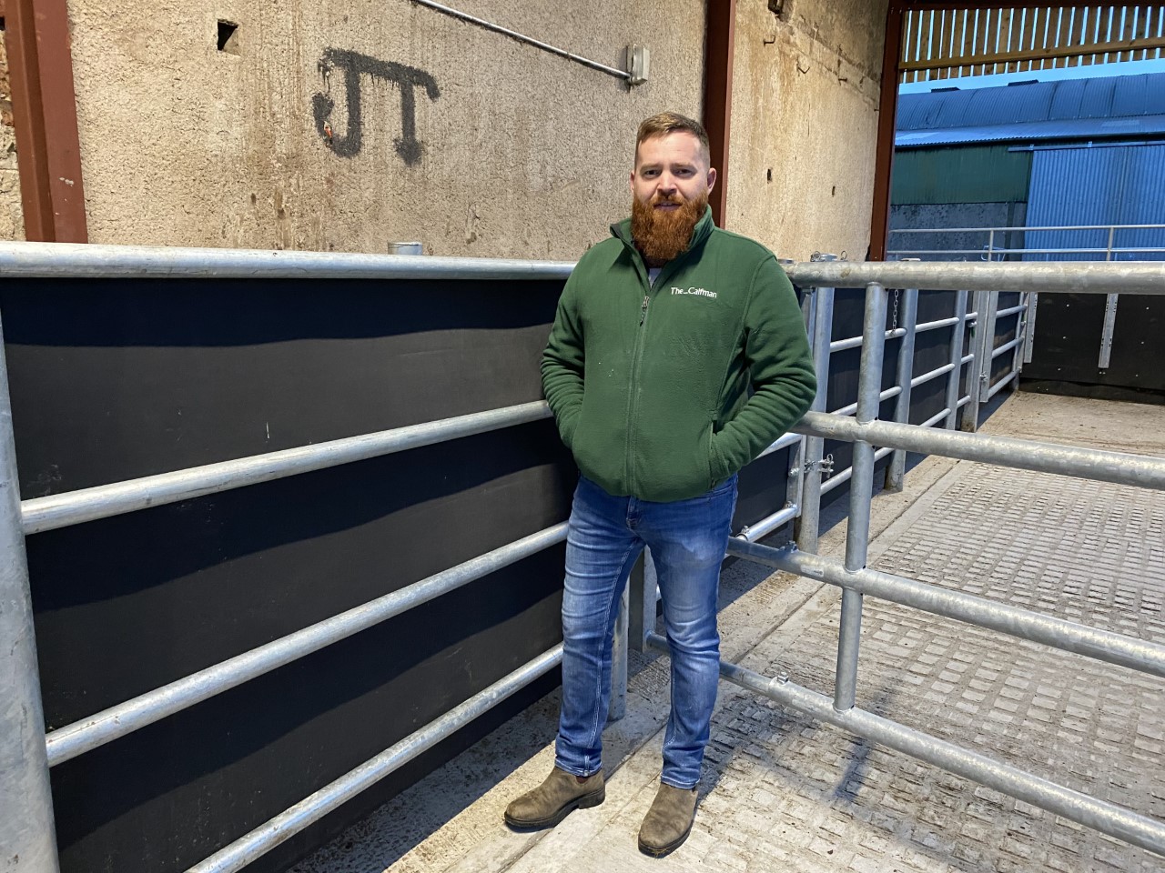 Glen Crooks standing beside the new handling unit on the farm