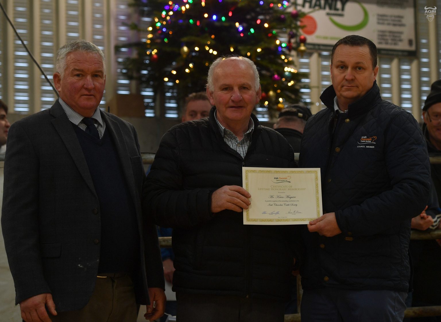 Kevin Maguire receiving his honorary membership from society president Oliver Connolly and Judge for the day Will Owen