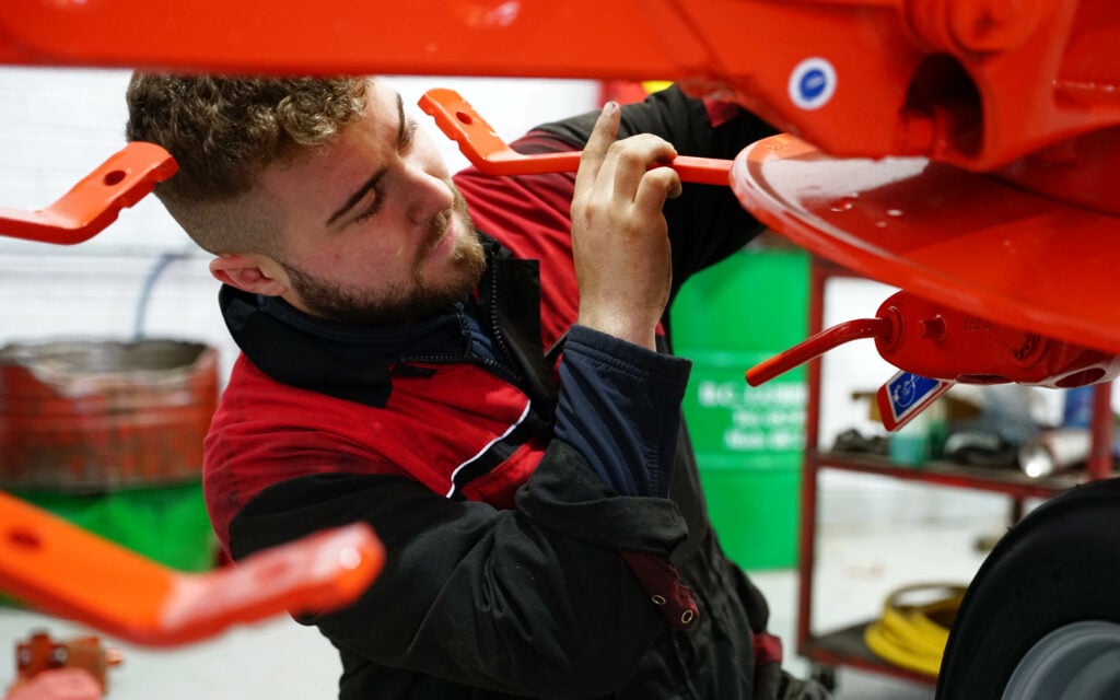 Nathan Butler assembles a tedder ready for the open day