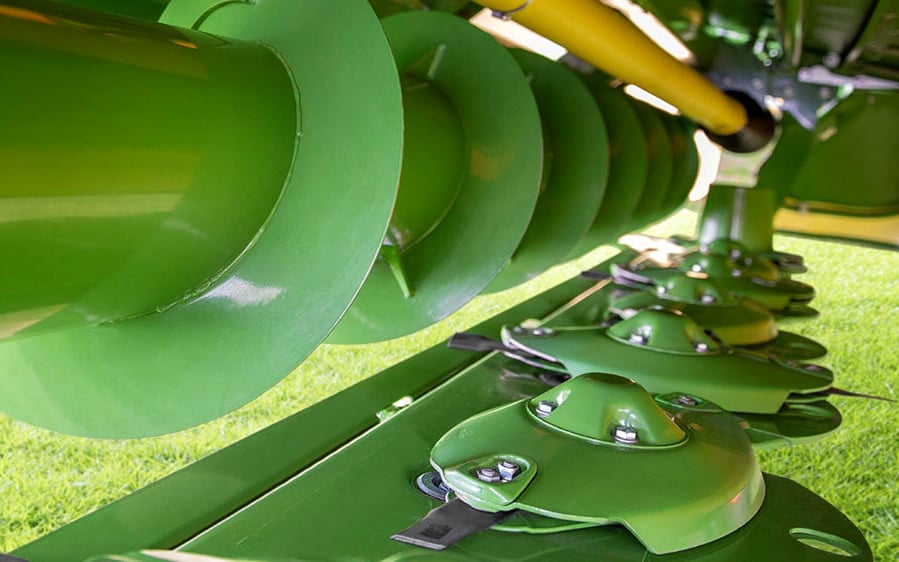Without a conditioner, the B 950 Collect is a lighter mower, relying on augers rather than belts for grouping